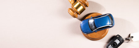 Judge gavel and car model with keysの写真素材