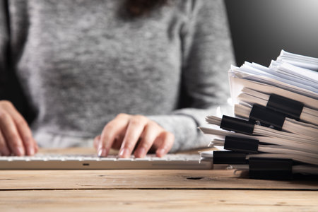 business woman working in computer with documents