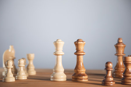 chess pieces on the wooden table backgroundの写真素材