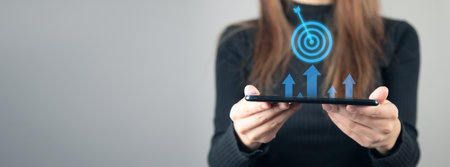 business woman holding tablet with target icon