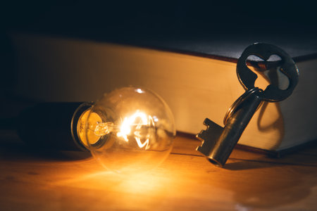 Idea concept,key with lightbulb and book on table