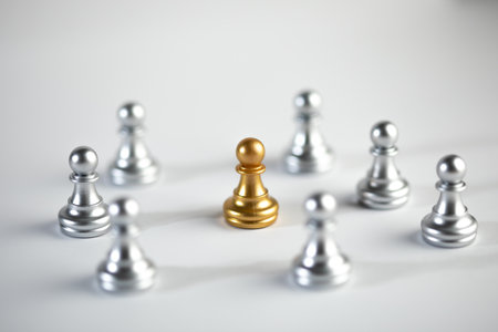 Silver and gold chess on white background.の写真素材
