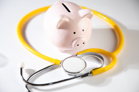 Piggy Bank and Stethoscope Isolated on a White Backgroundの写真素材