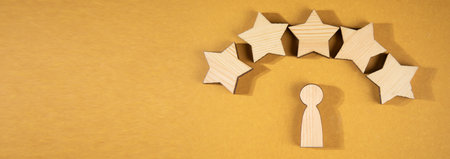 Wooden human figures with stars. Best customer evaluation and satisfactionの写真素材