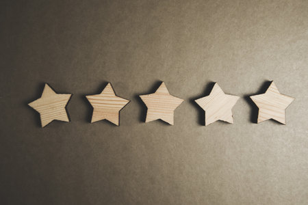 Wood block five star on dark tableの写真素材