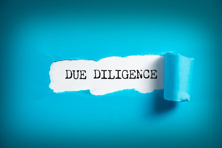 Due diligence text on the torn paper.の写真素材