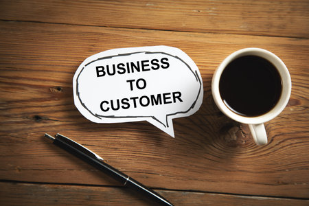 business to customer text on paper on working tableの写真素材