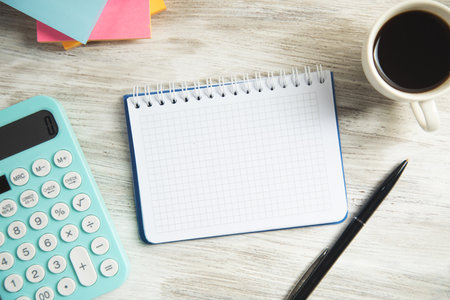 Business analysis concept. Notepad with calculator and coffee