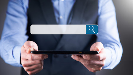 Man hands and tablet (PC). Concept of search in internet.