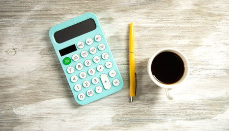 cup of coffee with calculator on working table