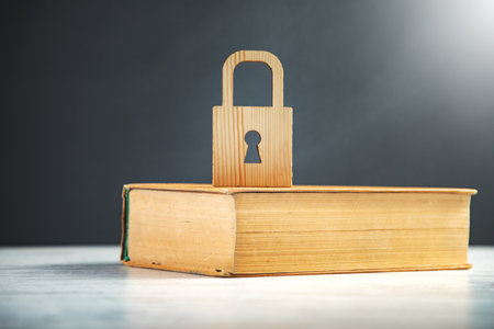 Wooden lock on the book on tableの写真素材