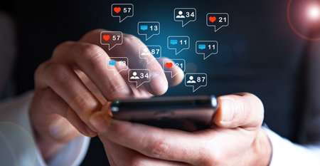 Hand hold smartphone play social media with communication icon. Technology concept.