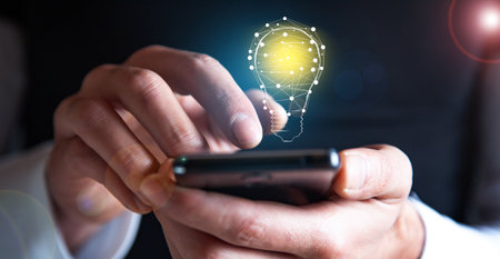 Idea concept, man holding phone with light bulb iconの写真素材