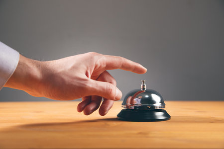 man finger on the call button on tableの写真素材