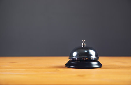 hotel reception service desk bell on dark background