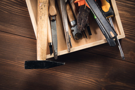 different construction tools on wooden background with copy spaceの写真素材