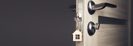 Closeup view of door with key open into roomの写真素材