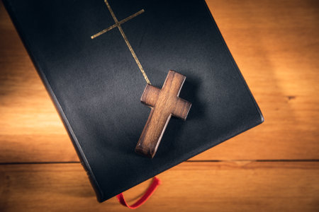 Closeup of simple wooden Christian cross on holy Bibleの写真素材