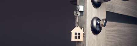 A key in a door lock with house icon on itの写真素材