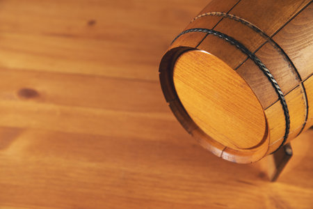 vintage oak barrel on a wooden table backgroundの写真素材