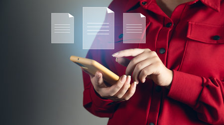 Document Management System. Woman holding phone and file in screenの写真素材