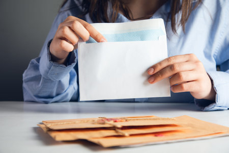 Woman holding and reading letters.の写真素材