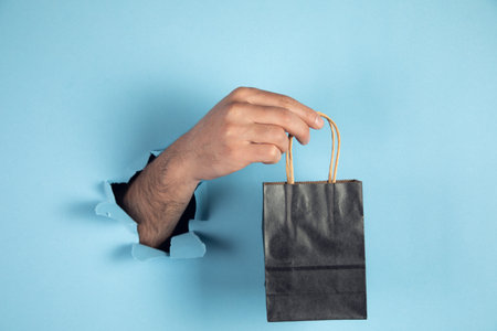 man hand hold paper bag mock up