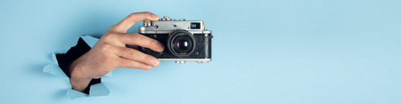 man hand holding vintage camera.