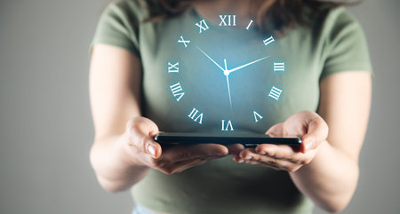 Businesswoman holding tablet computer with clock icon