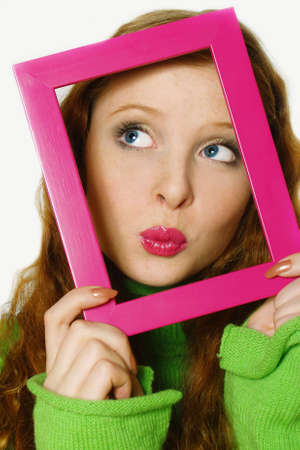 Face of the young beautiful girl in a frame. The kissing girl      の写真素材