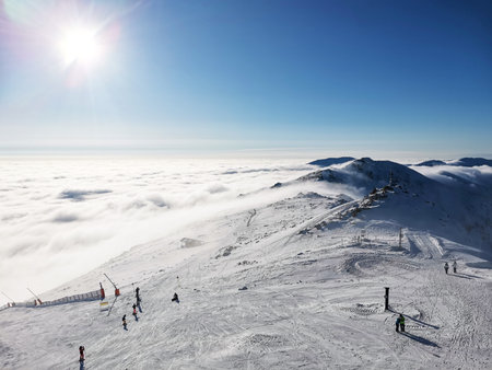Mountain peak with people on a clear sunny day. View of mountains above clouds. Bokeh effectの写真素材