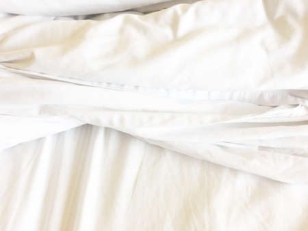 White blanket on the couch in the bedroom.