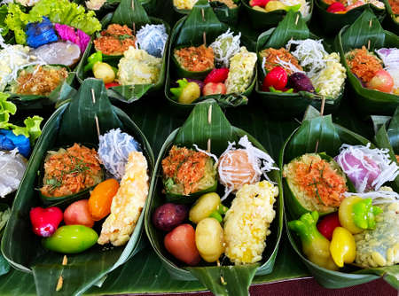 Delicious Thai Traditional Dessert Khanom Foi Thong and Thong Yip with Khanom Mo Kaeng in banana leaves container.の写真素材