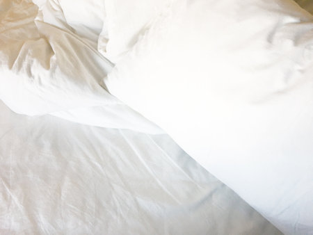 after waking up in theâ morning. The crinkle blanket on the bed in the hotel with the sunâlightâ onâ theâ blanket.の写真素材