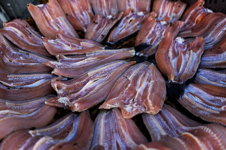 Dried fish on the bamboo grid in the sunny day.
