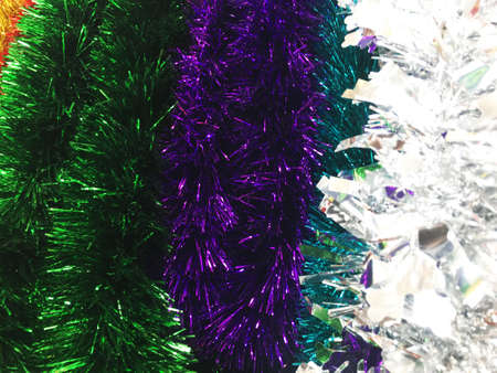 Colorful Christmas tinsel. New year's fluffy confetti. Sparkling ornament decoration concept . holiday background.の写真素材