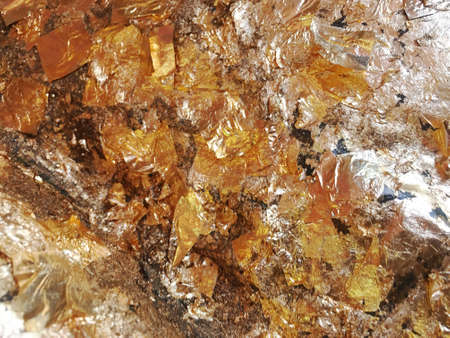 Texture of a thin crumpled sheet of foil. Crumpled foil background. Stock photo foil. Gold chrome...
