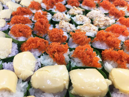 Thai desserts coconut custard, Shrimp, Fuzz, Sweet coconut on Sticky rice on green banana leaf.の写真素材