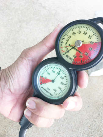 Scuba diving pressure and depth gauge close up.の写真素材