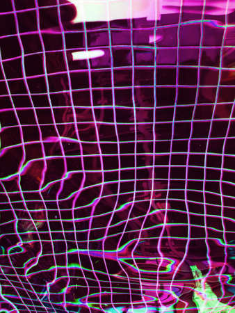 Pink swimming pool water with tiles and palm tree shadow.の写真素材
