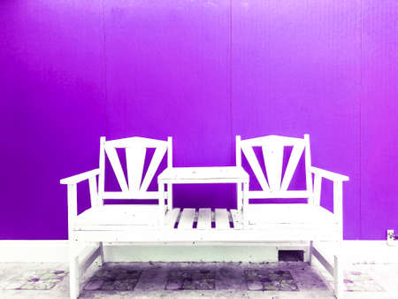 white old chair with purple background.の写真素材