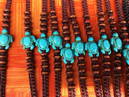 Many colorful necklace, seashell bracelets, fangs as amulets and other jewelry for sale. Exotic...