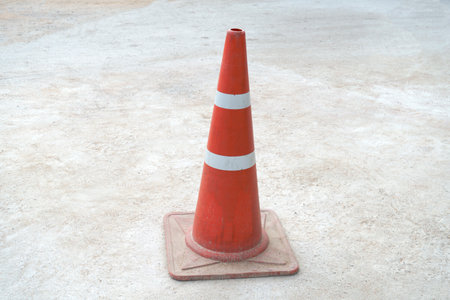 Striped orange cones on the asphalt road.