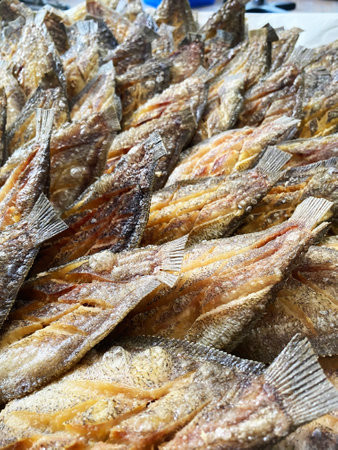 Deep fried Snakeskin gourami fish with spawns on white arches oil paper sheet.の写真素材