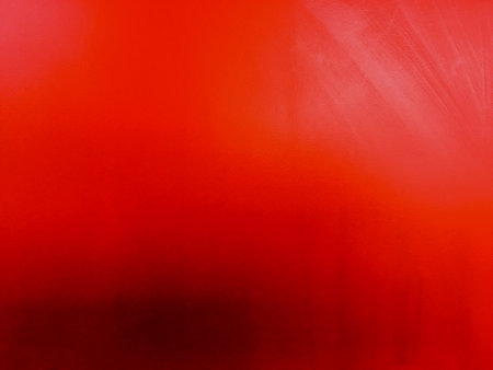 Empty red textured wall close up with shadows. Sparse texture and background.