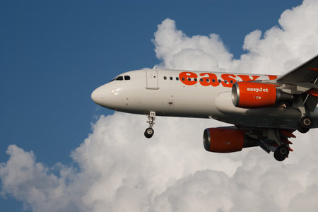 Corfu, Greece - May 29, 2009: Passenger airplane Easy Jet in the sky, cloudy blue sky, side view, landing, takeoff, horizontal orientationのeditorial素材
