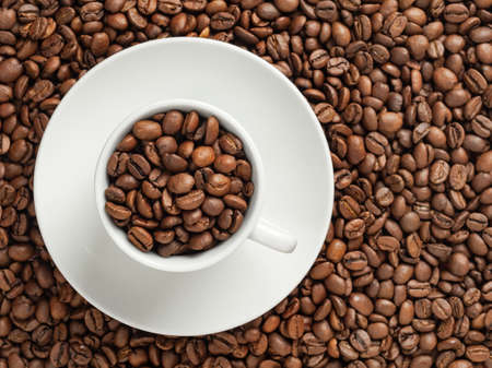 white cup with coffee beans background.の写真素材