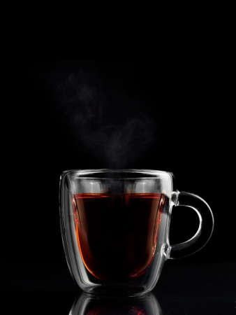 transparent cup of tea with dark background.の写真素材