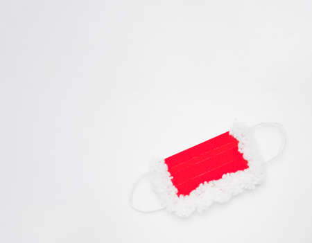 protective mask for Santa Claus, red and white on a white background imitating snow, at the bottom...