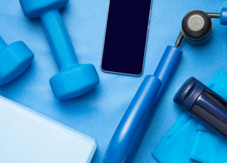 Fitness set in blue - dumbbells, mat,  phone, towel, yoga block, expander (flat lay composition,...